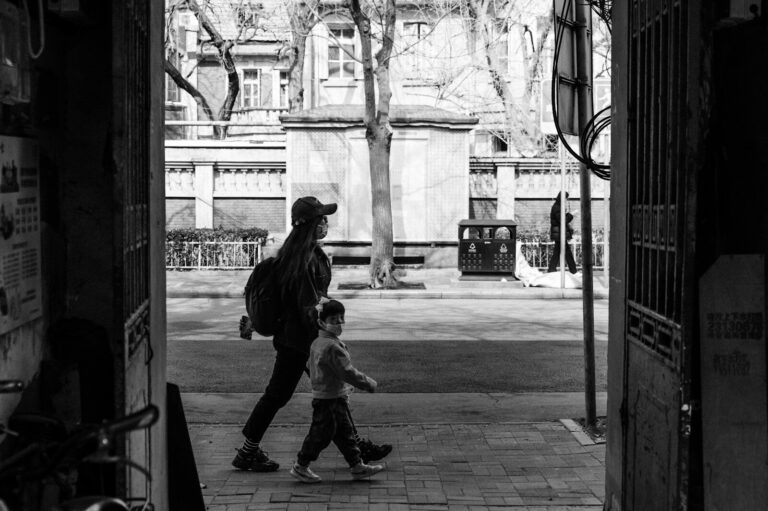 A black and white photo of a person and a child