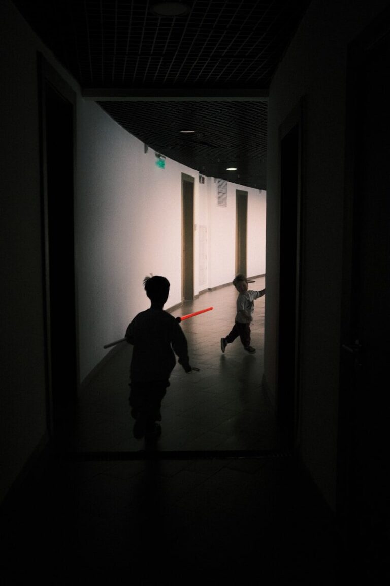 a couple of people that are walking down a hallway