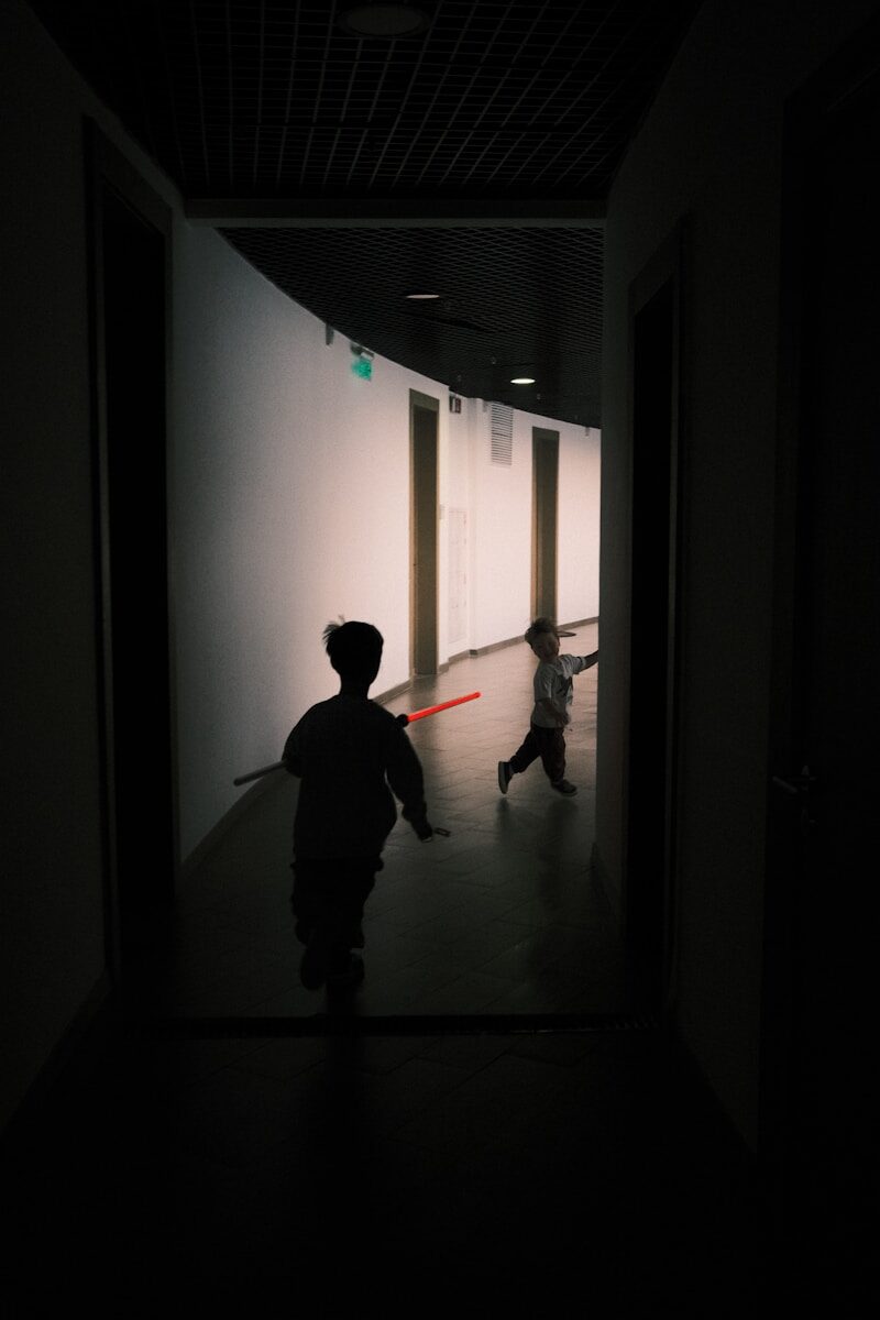 a couple of people that are walking down a hallway