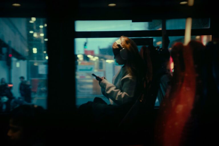 Woman on a bus looking at her phone